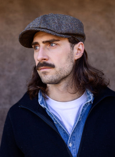 Man in tweed cap with a sporting, country style.