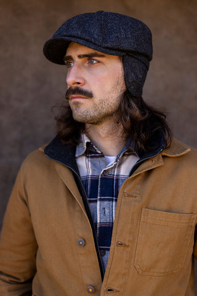 Man in a grey Flat cap with fold-down earflaps