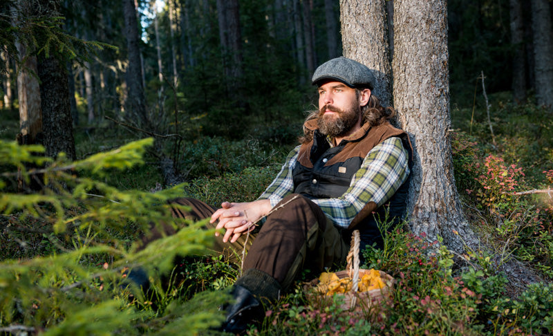 Man in forest with a tweed Bakerboy cap
