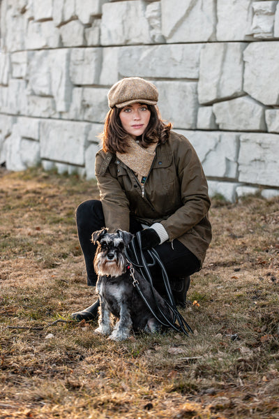 Country style girl sporting in tweed cap  