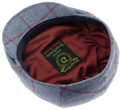 Flat cap with in Donegal Tweed with red lining.