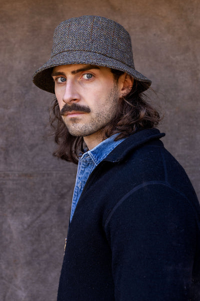 Man in green Harris Tweed Bucket hat