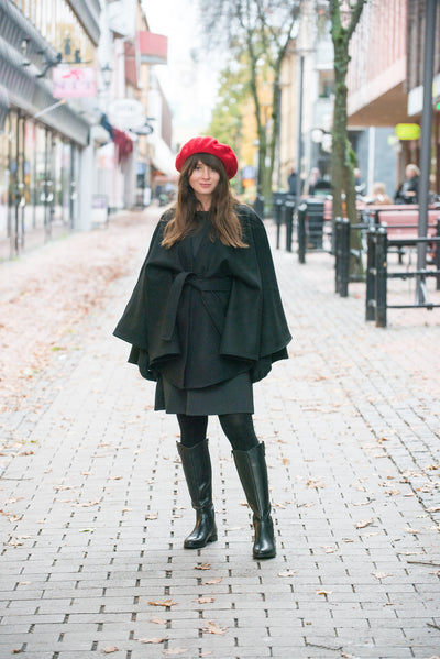 Woman with red beret and black cape