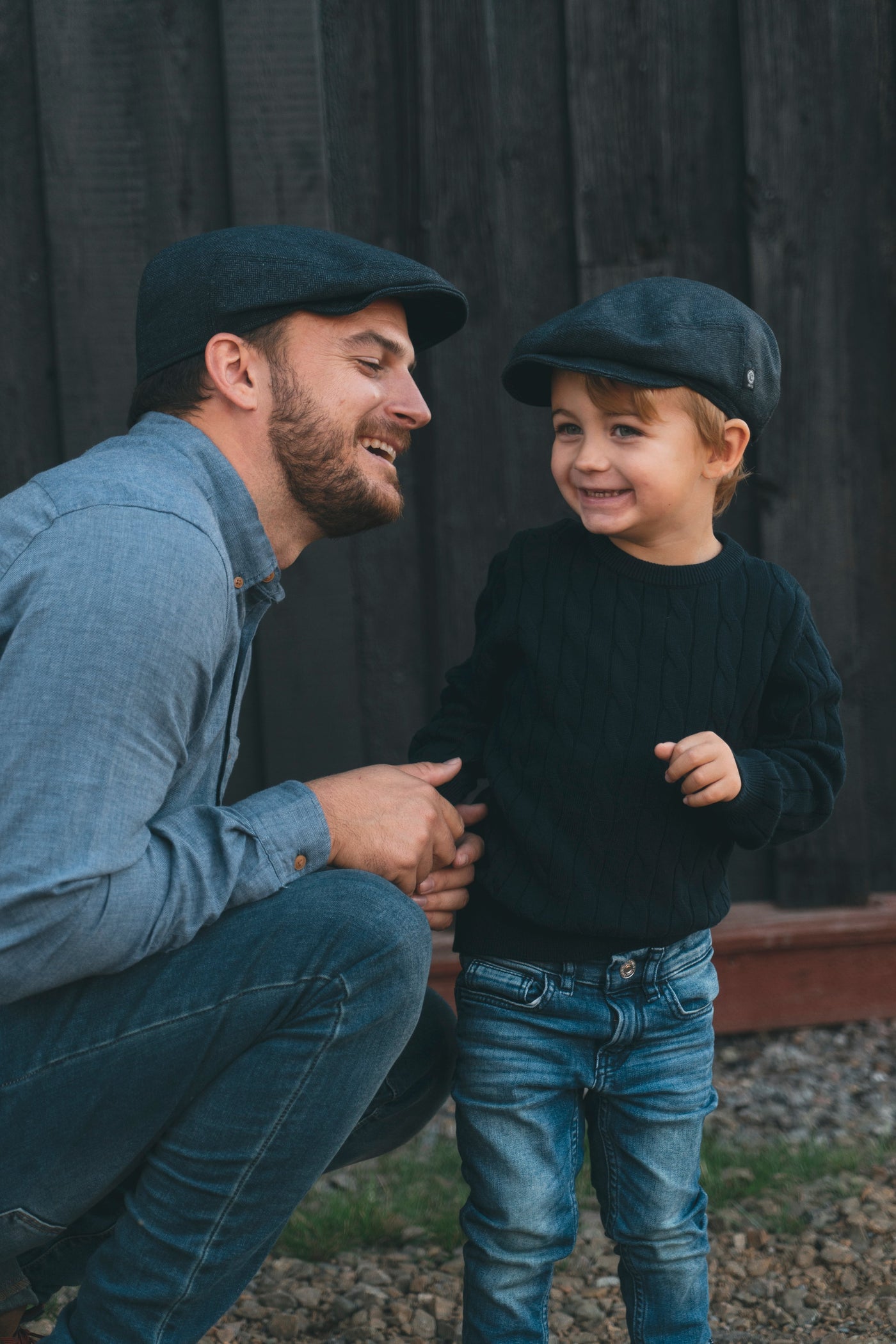 Father and son in same blue flat cap 